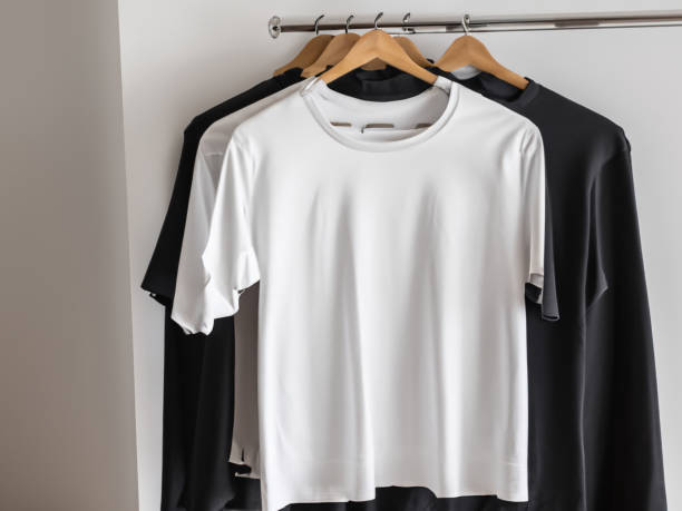 istock Realistic tshirt mockup | Blank black and white t-shirt on hanger, design mockup. Clear plain cotton tshirt mock up template. Apparel store logo mock branding display 1605414801