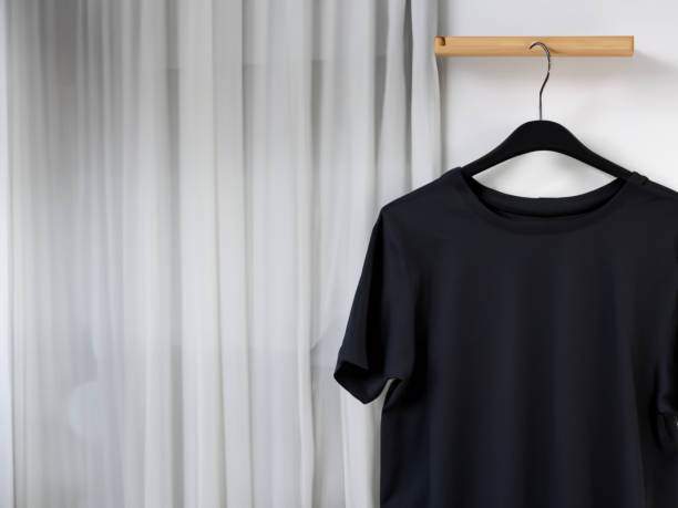 istock Realistic tshirt mockup | Blank black and white t-shirt on hanger, design mockup. Clear plain cotton tshirt mock up template. Apparel store logo mock branding display 1605415357
