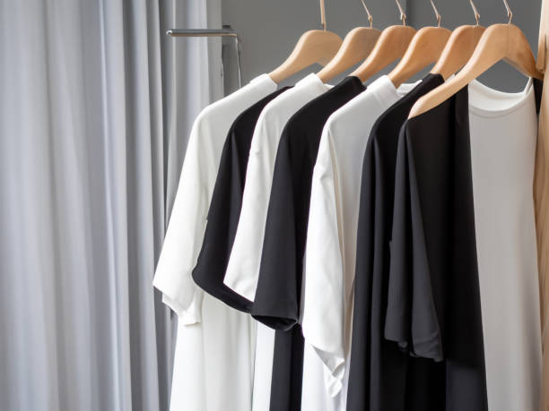 istock Realistic tshirt mockup | Blank black and white t-shirt on hanger, design mockup. Clear plain cotton tshirt mock up template. Apparel store logo mock branding display 1605415361
