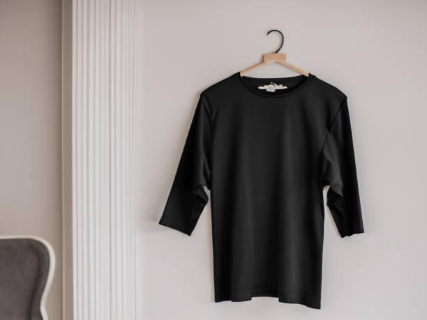 istock Realistic tshirt mockup | Blank black and white t-shirt on hanger, design mockup. Clear plain cotton tshirt mock up template. Apparel store logo mock branding display 1605415368