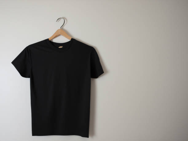 istock Realistic tshirt mockup | Blank black and white t-shirt on hanger, design mockup. Clear plain cotton tshirt mock up template. Apparel store logo mock branding display 1605415956