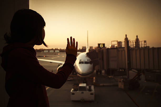 istock Girl waves goodbye at departing airplane 160541705