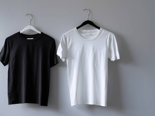 istock Realistic tshirt mockup | Blank black and white t-shirt on hanger, design mockup. Clear plain cotton tshirt mock up template. Apparel store logo mock branding display 1605417602