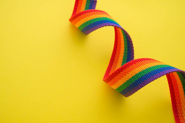 istock Rainbow headband LGBT like a LGBT pride flag on yellow background with copy space. 1605421445