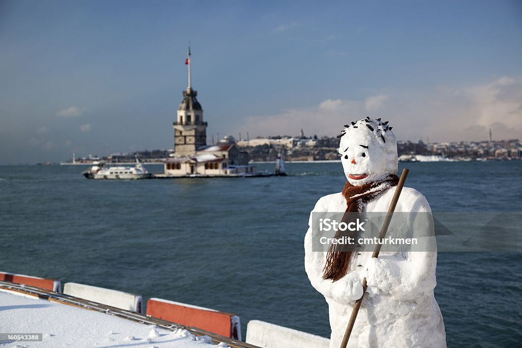 Snowman in Istanbul, Turkey Snowman and Maiden's Tower with Historical Peninsula, where is the center of ancient Istanbul. Snowman Stock Photo