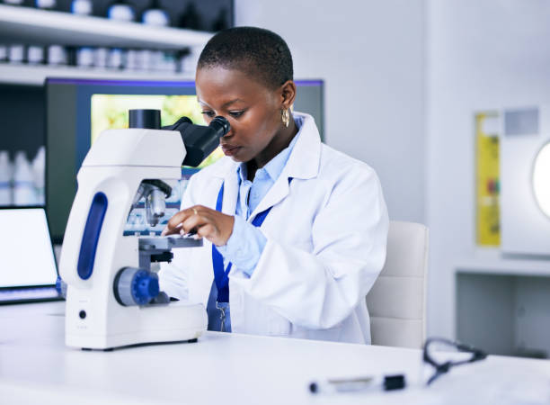 istock Scientist, black woman and microscope, analysis and science study with medical research and biotechnology in lab. Female person, doctor and pathology, check test sample with scientific experiment 1605434095