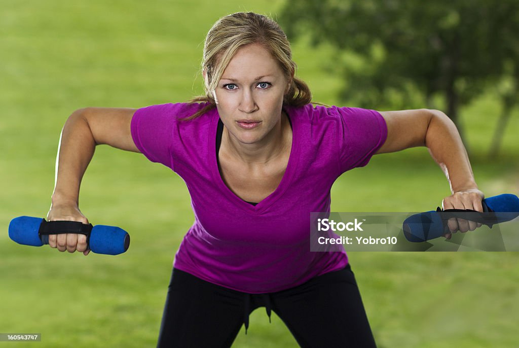 Beautiful Fitness Woman Training A beautiful, healthy fitness working out and training with weights Active Lifestyle Stock Photo
