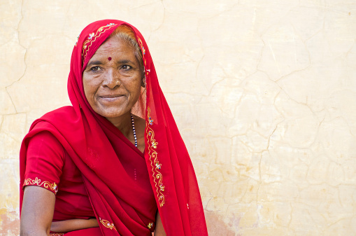 Portrait of Indian woman in sari. Sari is decorated with metal thread embroidery and beads. Agra, Rajasthan, India.