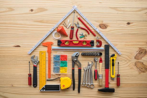 istock Flat lay of construction tools as house model on wooden background with copy space. 1605453676