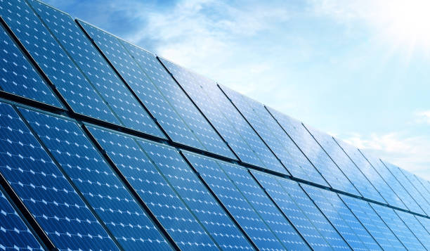 istock Solar panels on the blue sky background. Alternative clean green energy 1605455871