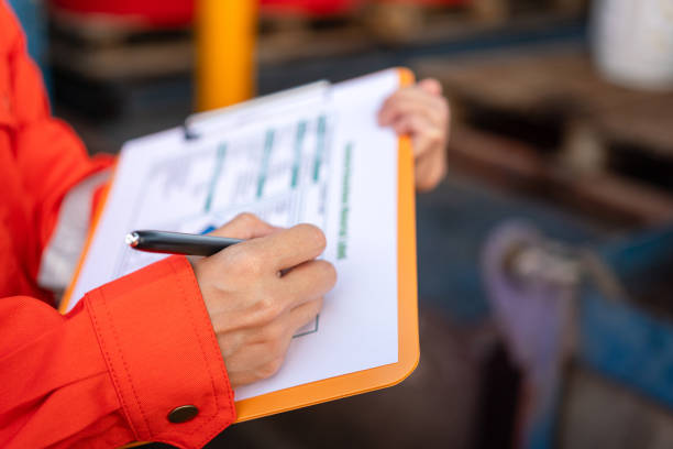 istock Checking on the chemical hazardous material form. Industrial safety working. 1605456995