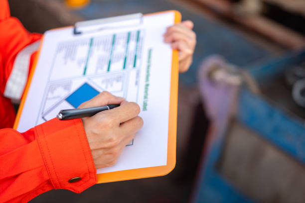 istock Checking on the chemical hazardous material form. Industrial safety working. 1605457538