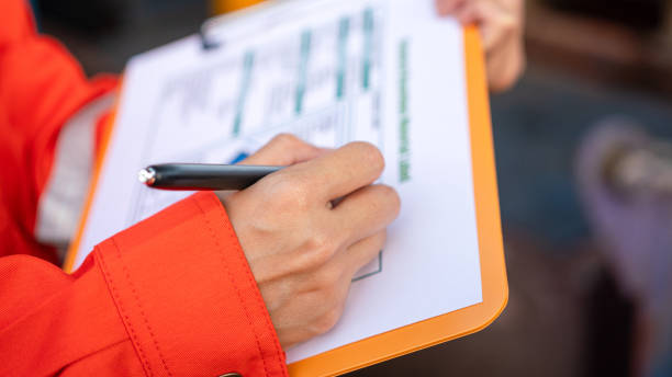 istock Checking on the chemical hazardous material form. Industrial safety working. 1605457578