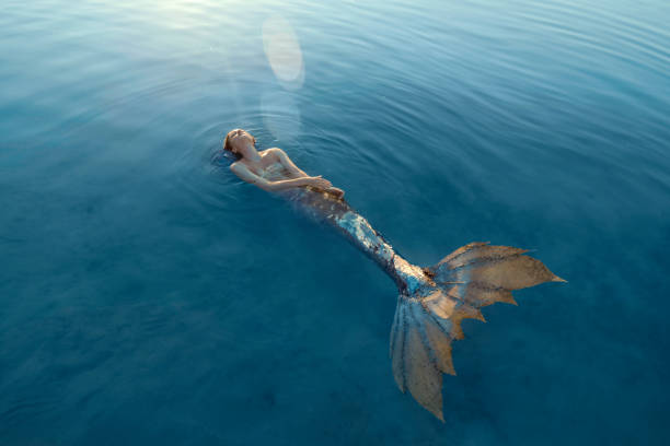 istock Beautiful redhead woman as mermaid 1605466813