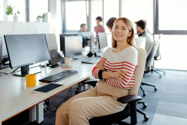 istock Group Leader at the Office in Front of Her Workers 1605475576