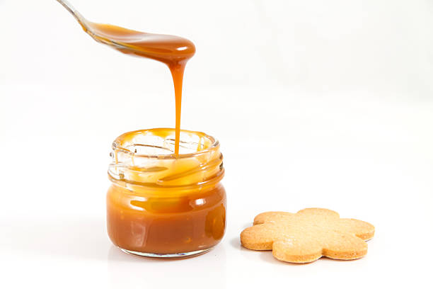 istock Pouring caramel in a small jar with spoon, horizontal 160547875