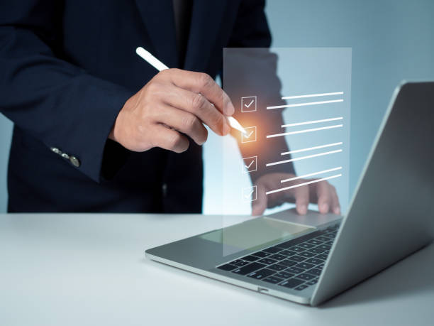 istock Businessman is checklist and filling survey form online. Document management system, DMS.  Quality control and accuracy Check 1605490682