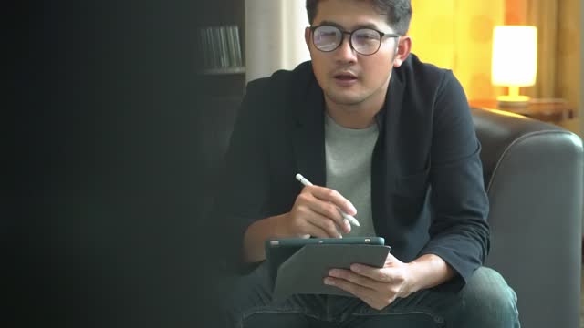 Asian man therapist writing notes during a counseling session Depression Counseling.