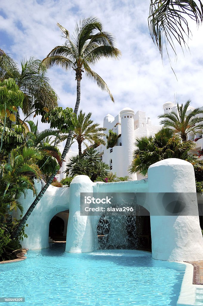 Swimmingpool mit Wasserfall und Gebäude von Luxus-hotel - Lizenzfrei Schwimmbecken Stock-Foto