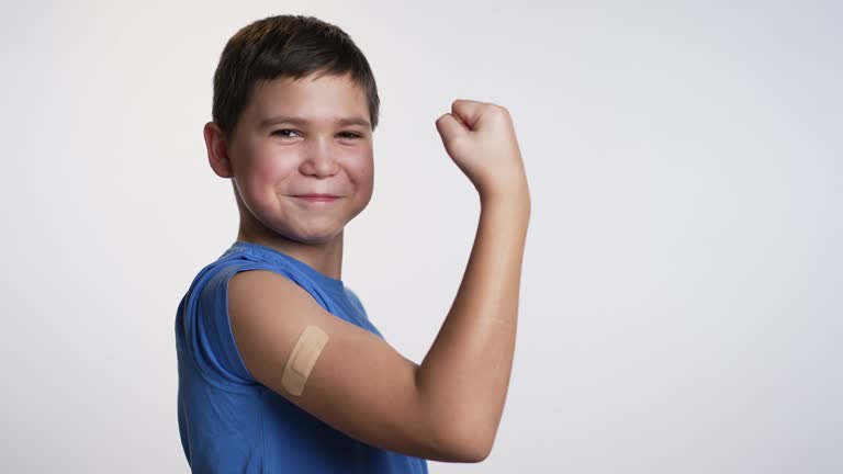 A boy with a patch on his shoulder. Vaccination concept