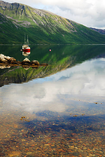 istock Water reflecting the blue sky and green mountain. 160549580