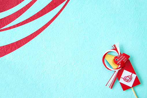 Scissors cutting red ribbon or tape against a white background.