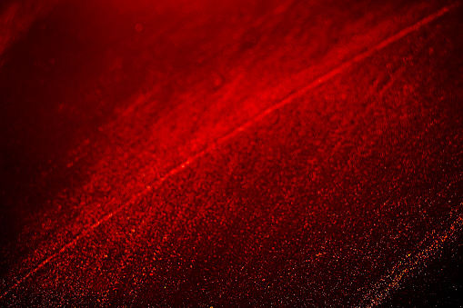 Black dark red orange brownbokeh shiny glitter abstract background with space. Twinkling glow stars effect. Like outer space, night sky, universe. Rusty, rough surface, grain. Abstract bokeh with red orange