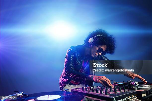 Dj Playing In A Nightclub With Lights Behind Them Stock Photo - Download Image Now - DJ, Party - Social Event, African Ethnicity