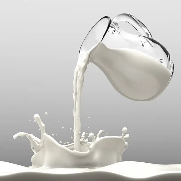 Pouring Milk from a transparent bottle to a wavy milk pool.  Top lighting with good reflection on bottle body and milk. Neutral tone background environment. Milk drops with motion blur reflect pouring in action.