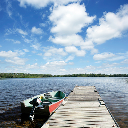 fishing boat on wilderness lake with bright sky, square frame (XXXL)