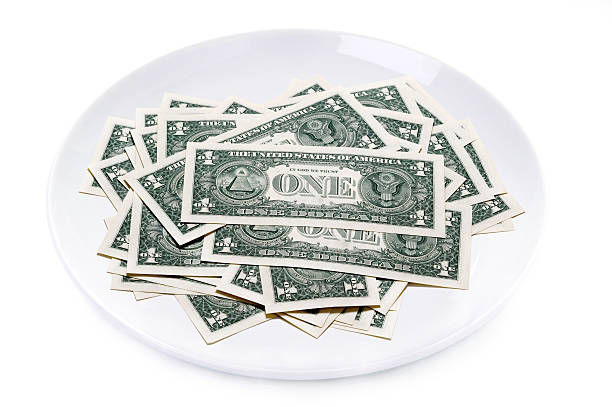 istock one dollar bills on a plate isolated 160550505