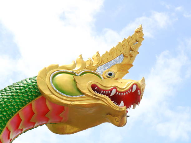 istock Head of green serpent and sky. 1605506096