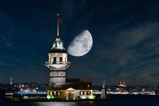 Istanbul Maiden Tower (kiz kulesi) with full moon - Istanbul, Turkey.