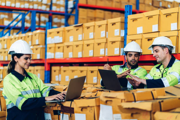 istock Warehouse worker working in warehouse storage. Foreman or worker work at factory site check up products in site. Inventory worker working in  factory Storehouse 1605524380