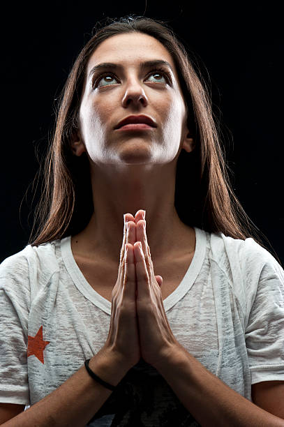istock Hispanic young woman praying 160553413