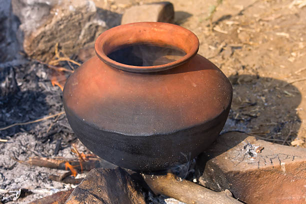 istock Clay pot with food on fire 160555148