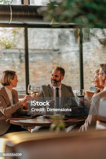 istock Friendly businesspeople toasting. 1605554039