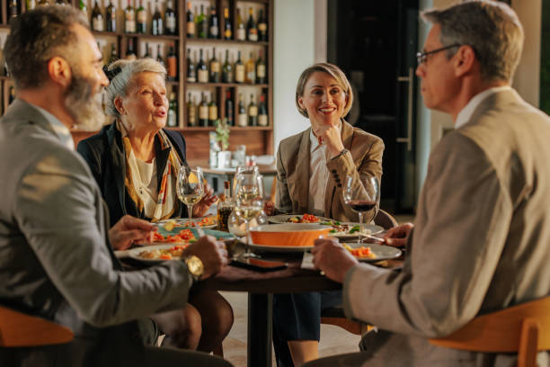 istock Business partners in casual lunch. 1605557904