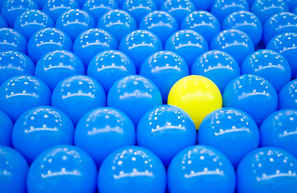 istock Unique yellow ball among blue balls 160555915
