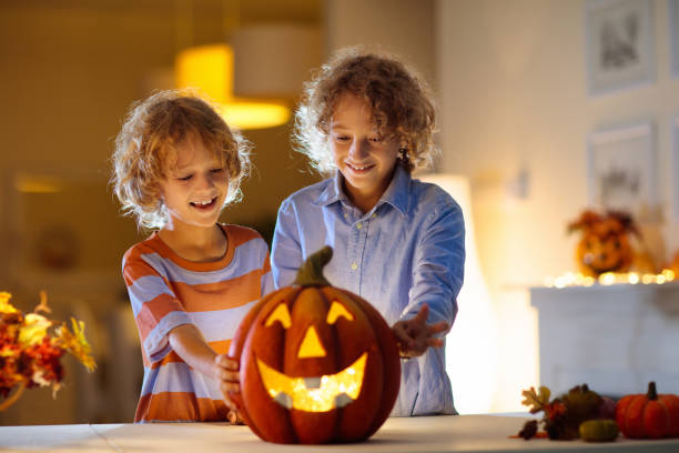 istock Family carving pumpkin for Halloween 1605583806