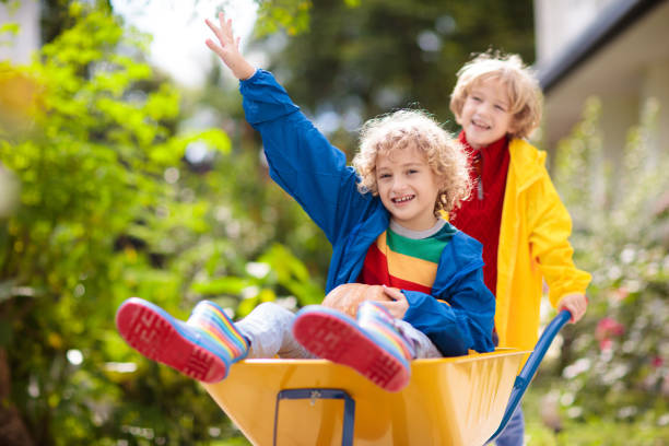 istock Kids on pumpkin patch. Child autumn outdoor fun. 1605584873