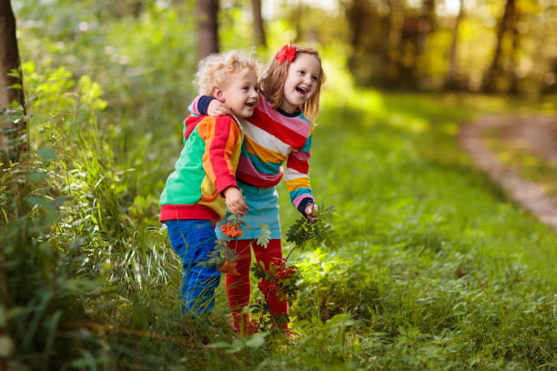 istock Kids play in autumn park 1605586999