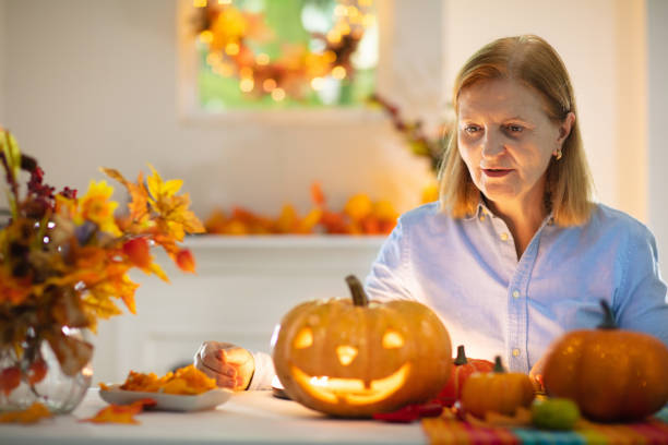 istock Family carving pumpkin for Halloween 1605589083