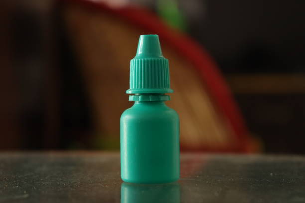 A Green Colored bottle Eye Drop for eye dryness in a bokeh Background