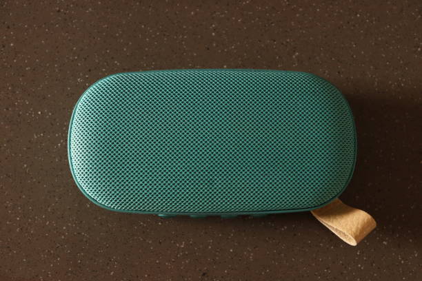 istock A Teal colour wireless handy pocket speaker On an isolated brown granite surface horizontally 1605608123