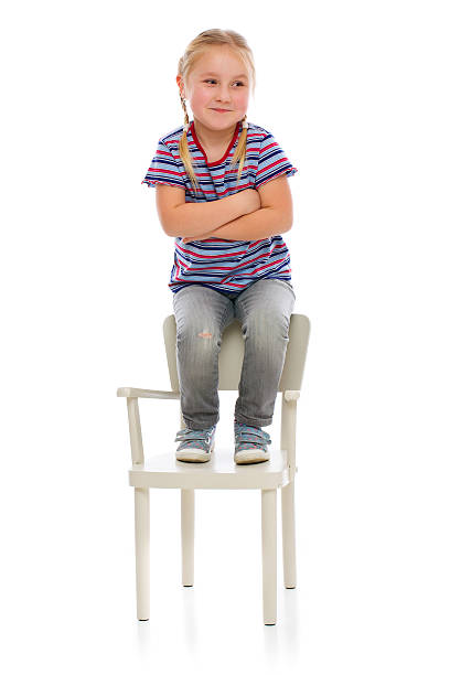 istock smiling girl sitting on a chair 160561451
