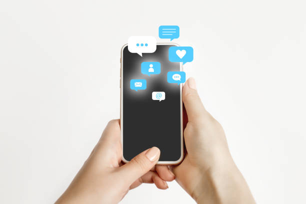 istock female hand holding and using a social media on mobile phone with notification icons 1605618559