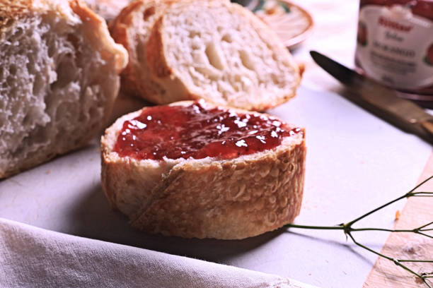Appetizing slice of bread topped with delicious strawberry jam