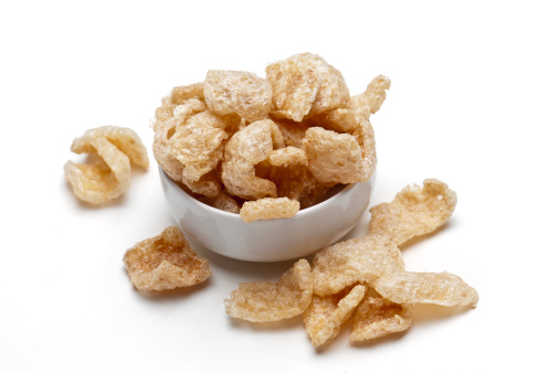 Small Bowl of Chicharrones close up on white background