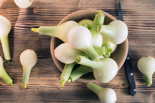 White young onion in a wooden bowl.